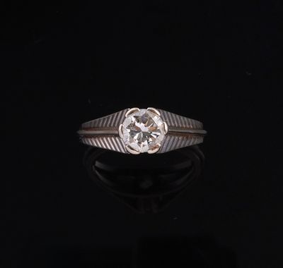 a close up of a diamond ring on a black surface