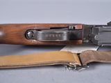 a close up of a rifle with a leather strap on it