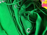 a green scarf and a pair of green shoes in a suitcase