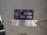 a sign on the side of a machine that is sitting on the ground