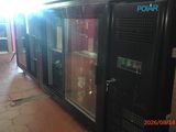 an image of a refrigerator in a room with a lot of glass doors