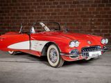 a red and white car parked in front of a brick wall