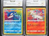two pokemon cards are sitting side by side on a black surface