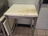 tiled floor in a kitchen with a small table and a refrigerator