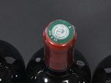 three bottles of wine that are sitting on a table