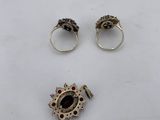 three silver rings and two rings with garnets