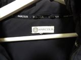 a black jacket that has a white hanger on it