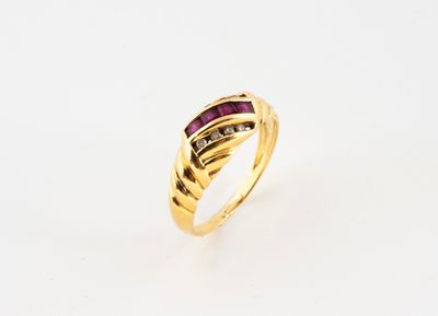a yellow gold ring with a ruby stone and diamonds