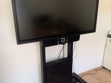 a flat screen tv sitting on a stand in a room