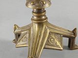 an antique brass candle holder with a bird on top