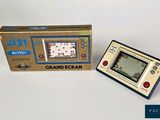 a small game console sitting next to a box