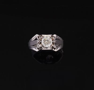 a diamond ring on a black surface