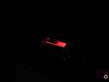 a red light in the dark that is shining on the ground