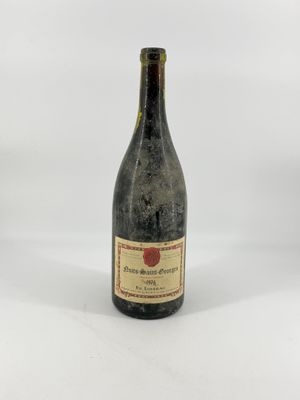 a bottle of wine sitting on top of a white table