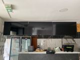 a picture of a kitchen with black cabinets and marble counter tops