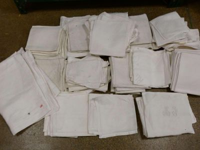 a pile of white napkins sitting on a table