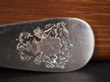 a close up of a knife with a coat of arms on it