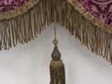 a picture of a curtain with a tassel hanging from it