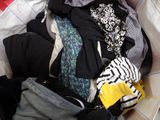 a pile of clothes in a bag on the floor
