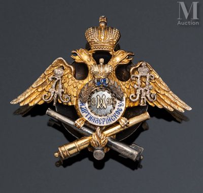 an image of a gold and silver broochle with a crown and two swords