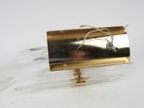 a gold plated object on a clear stand