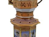 a decorative teapot with a painting on it