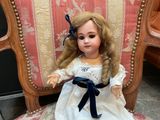 a doll that is sitting on a chair in a room