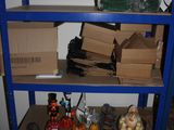 a blue shelf with boxes and other items on it