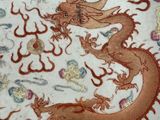 a plate with a dragon on it and a dragon on the plate