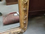 a mirror that is sitting on the floor in a room