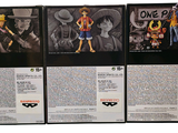 four one piece action figures on display in a display case