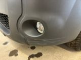 a close up of a car ' s front bumper with a light on
