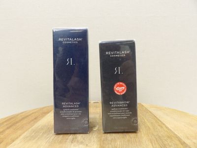 two boxes of skin care products sitting on a wooden table