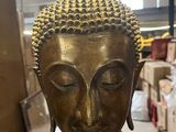 an image of a statue of a buddha sitting in a warehouse