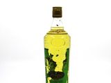a bottle of olive oil on a white surface