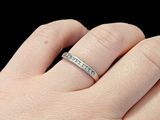 a woman ' s hand with a ring on it