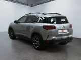 the rear end of a silver suv parked in a garage