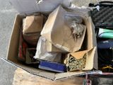 a cardboard box full of assorted items on the street