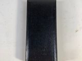 an image of a black leather case sitting on top of a white table