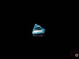 a close up of a blue diamond on a black background