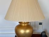 a lamp that is sitting on a table next to a remote control