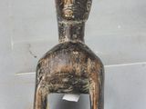 a small figurine of a man sitting on a chair