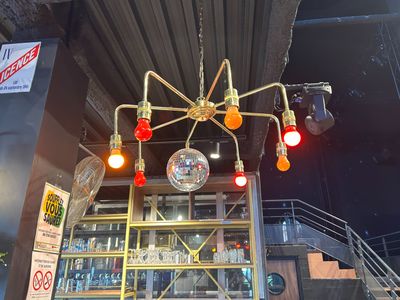 a chandelier that is hanging from the ceiling of a bar