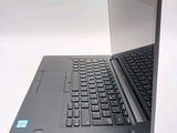 a laptop that is open on a white surface