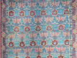 a blue and red rug with a medallion design