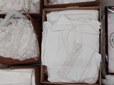 several boxes of white clothing are stacked on top of each other