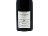 a bottle of wine that is sitting on a table