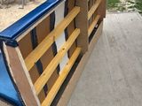 a bench made out of cardboard sitting on the sidewalk
