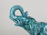 a blue elephant statue with a long horn on it ' s head