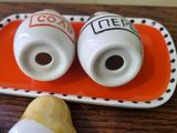 two salt and pepper shakers sitting on a tray
